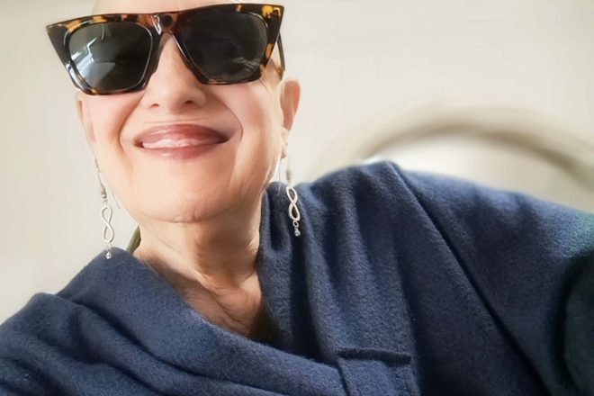 laura wearing blue cape